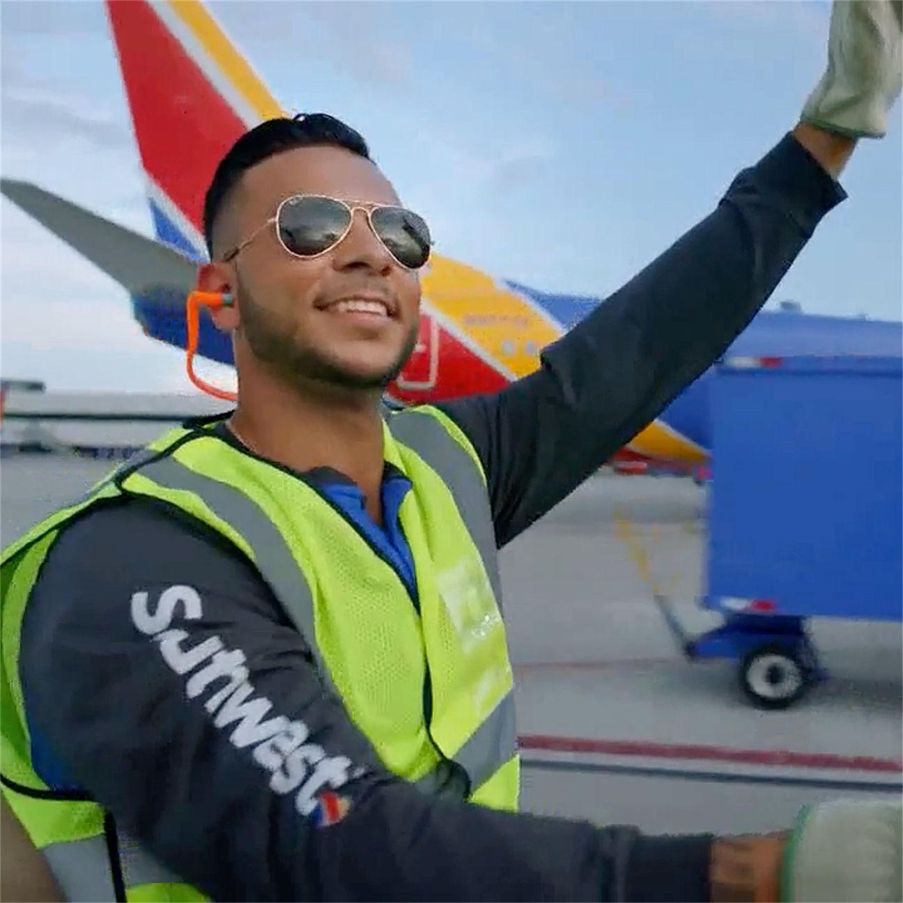 Southwest Airlines ramp agent waving on the tarmac